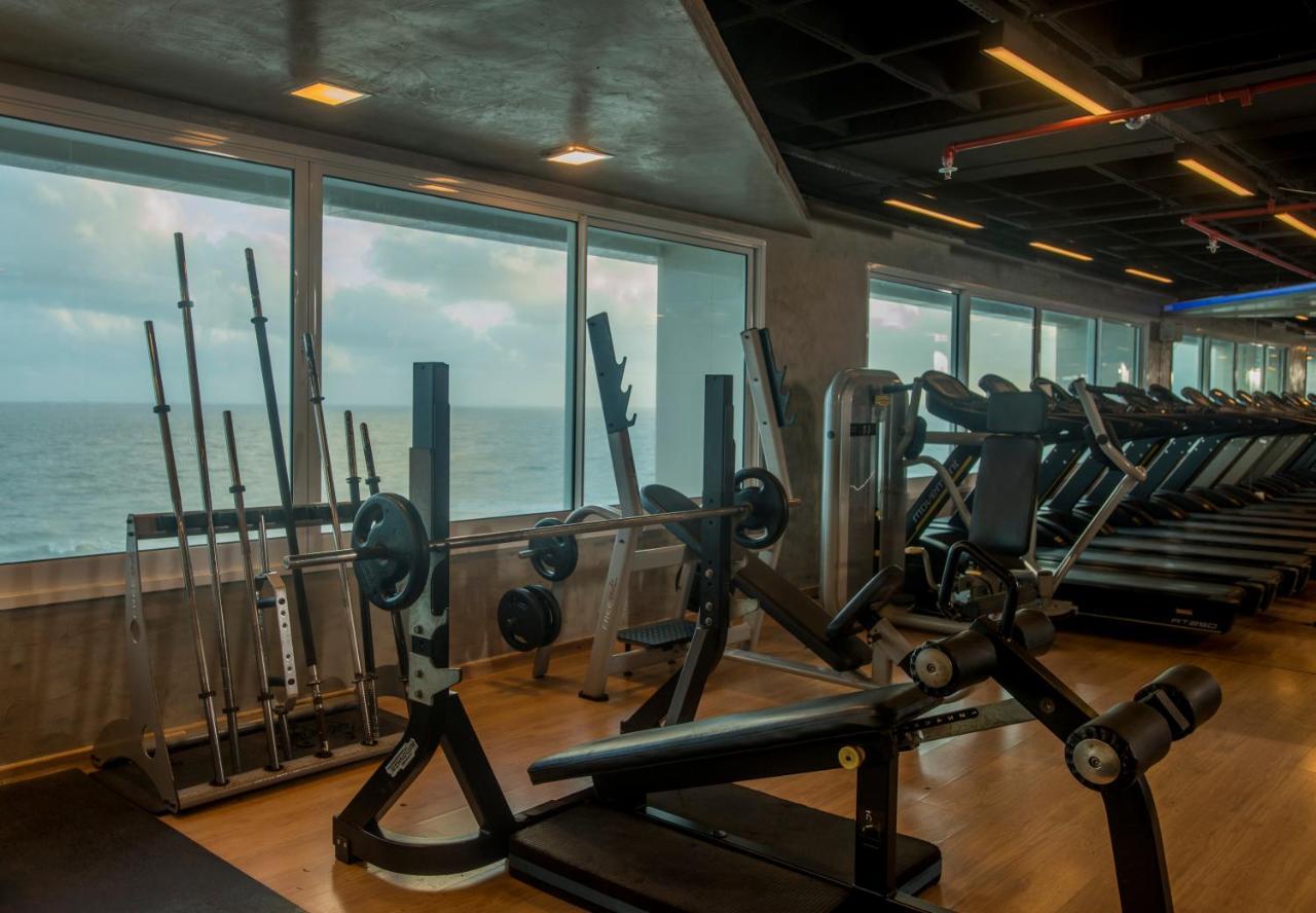 Hotel Luzeiros Sao Luis Eksteriør billede The photo shows an interior of a gym with large windows overlooking the ocean. The gym is equipped with various fitness machines and equipment, including weightlifting benches, barbells, and a range of other workout gear. There are also several tread